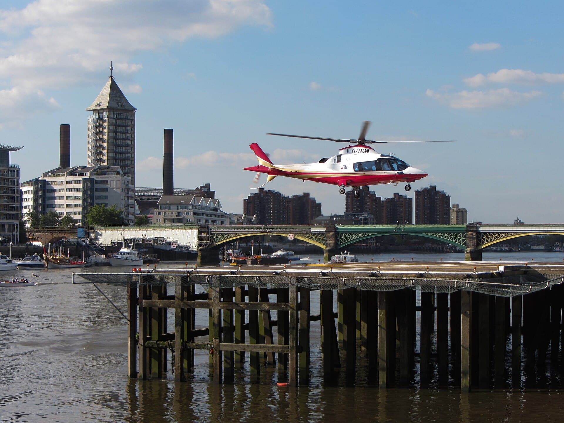 A helicopter landing at London Heliport, Battersea, on the Thames